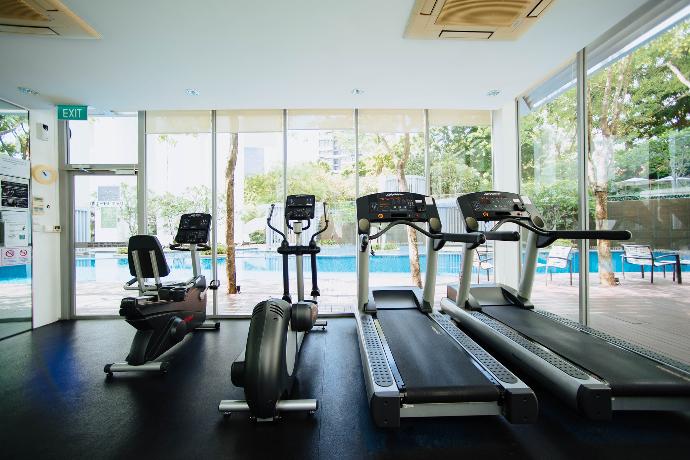 black and grey treadmill and stationary bikes